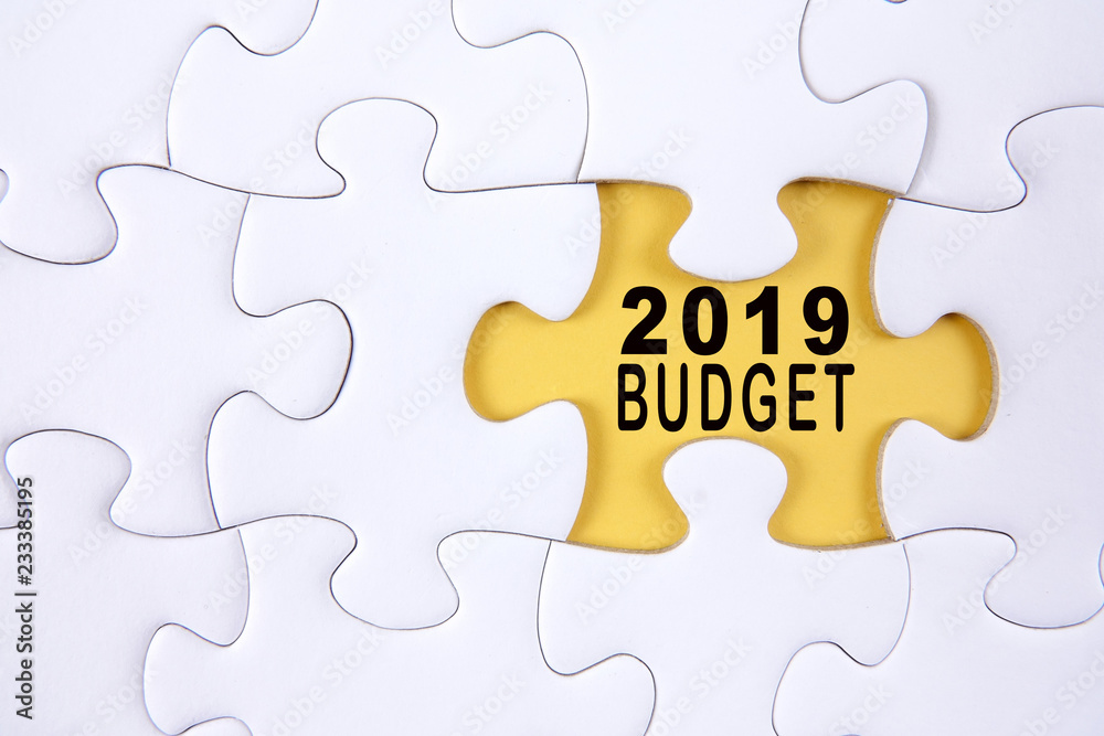 Business concept: 2019 BUDGET word on a jigsaw puzzle background. Business concept: 2019 BUDGET word on a jigsaw puzzle background.