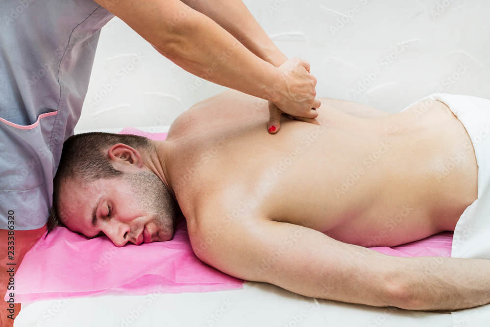 Young man on wellness treatments sports massage Young man on wellness treatments sports massage