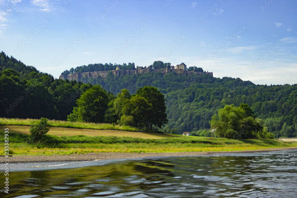 Obraz premium Beautiful view on Königstein castle from river Elbe in Saxony, Germany