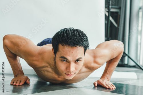 Asian men with beautiful muscles are doing push-ups