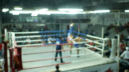 asian men thai boxing are punch and kick together with committee on canvas boxing stadium photo