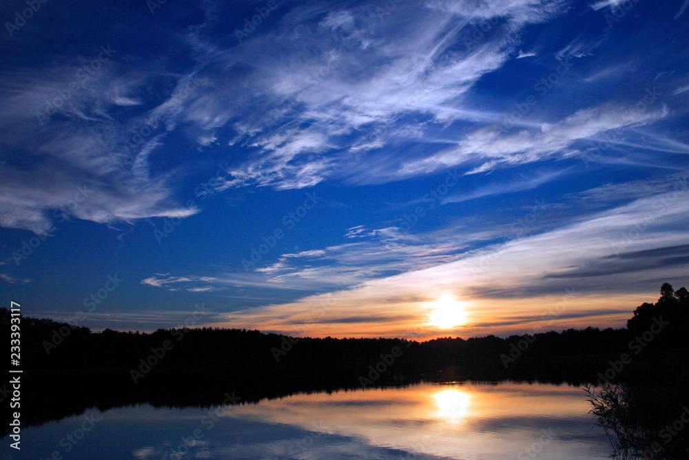 Summer sunset lake landscape over the Wejsunek lake in Wejsuny in Masuria region in Poland