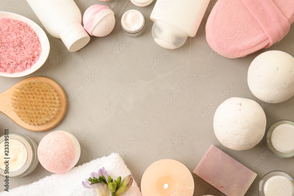 Flat lay composition with bath bombs, toiletries and space for text on grey background Flat lay composition with bath bombs, toiletries and space for text on grey background