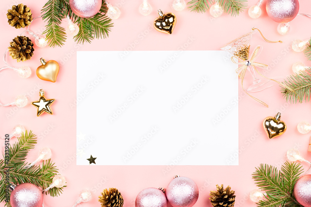 Christmas background with blank paper, fir tree branches, decorations on pink. Copy space Christmas background with blank paper, fir tree branches, decorations on pink. Copy space