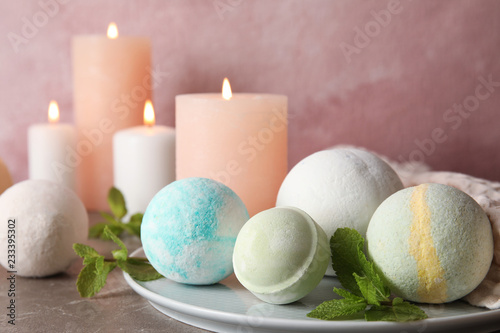 White plate with bath bombs and mint leaves on table
