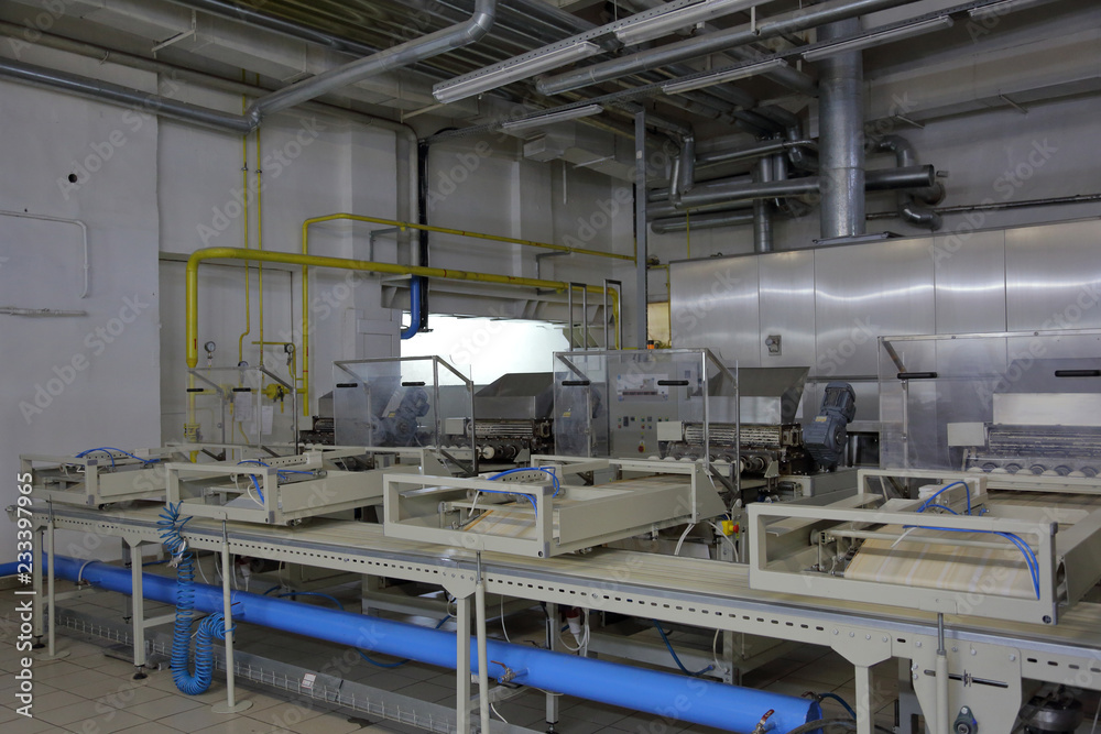 Industrial equipment and machinery at the factory of bread and sweets Industrial equipment and machinery at the factory of bread and sweets