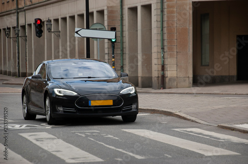 Modern electric car on the street of the old beautiful city.