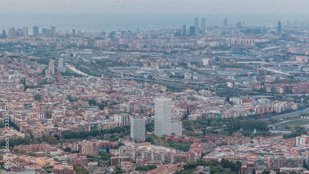 Barcelona and Badalona skyline with roofs of houses and sea on the horizon at evening timelapse