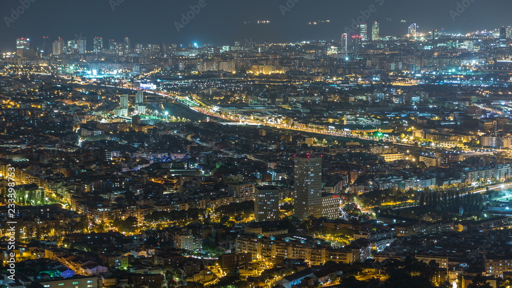 Barcelona and Badalona skyline with roofs of houses and sea on the horizon night timelapse