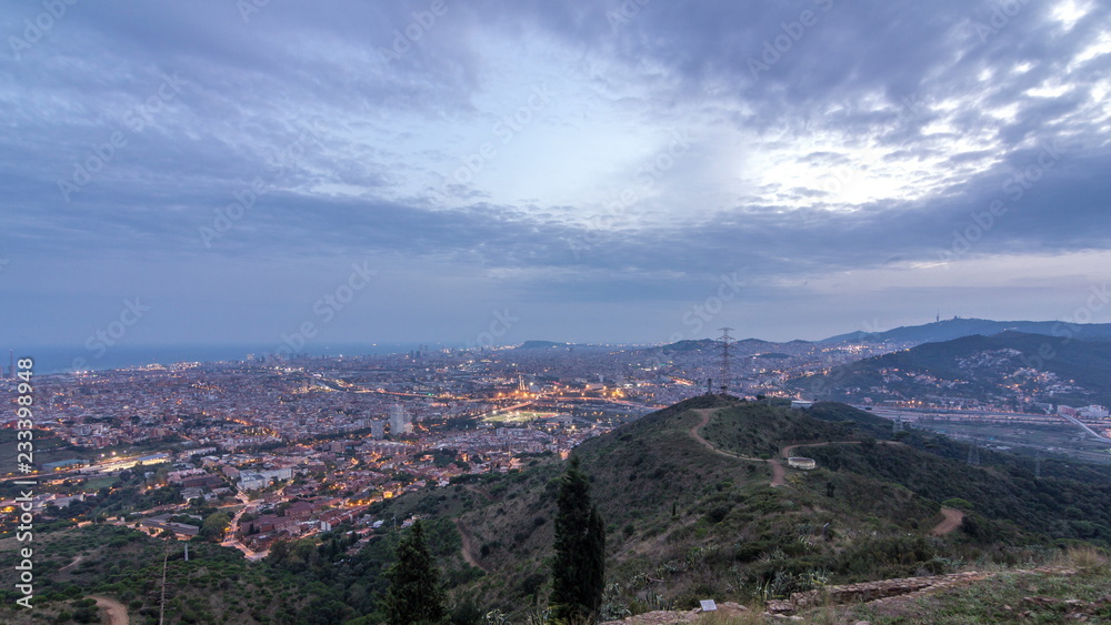Obraz premium Barcelona and Badalona skyline with roofs of houses and sea on the horizon day to night timelapse