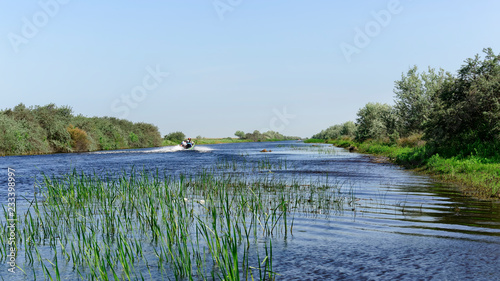 Touristic Speedboat on one of the many side arms of the river Danube in the Romanian Danube Delta