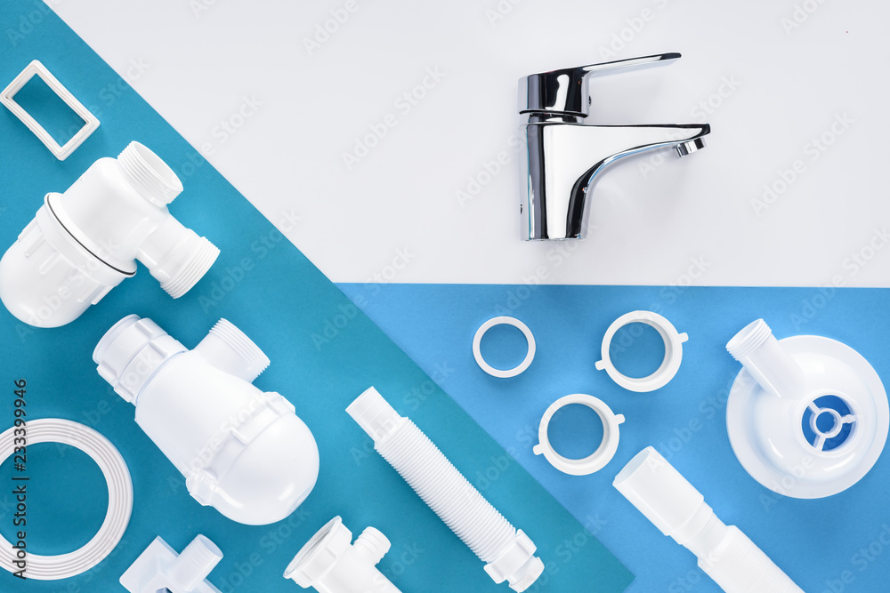 top view of plastic plumbing pieces and water mixer isolated on white top view of plastic plumbing pieces and water mixer isolated on white