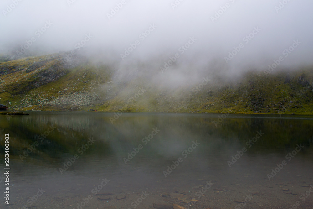 Foggy landscape over a lake