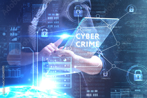 The concept of business, technology, the Internet and the network. A young entrepreneur working on a virtual screen of the future and sees the inscription: Cyber crime © Egor