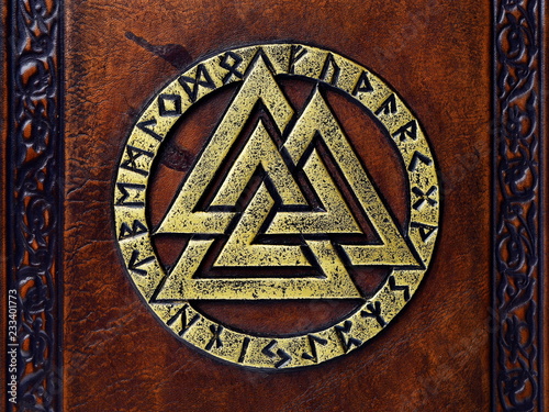 Obraz na plátně Vintage leather book with gilded Odin's symbol, surrounded with runes