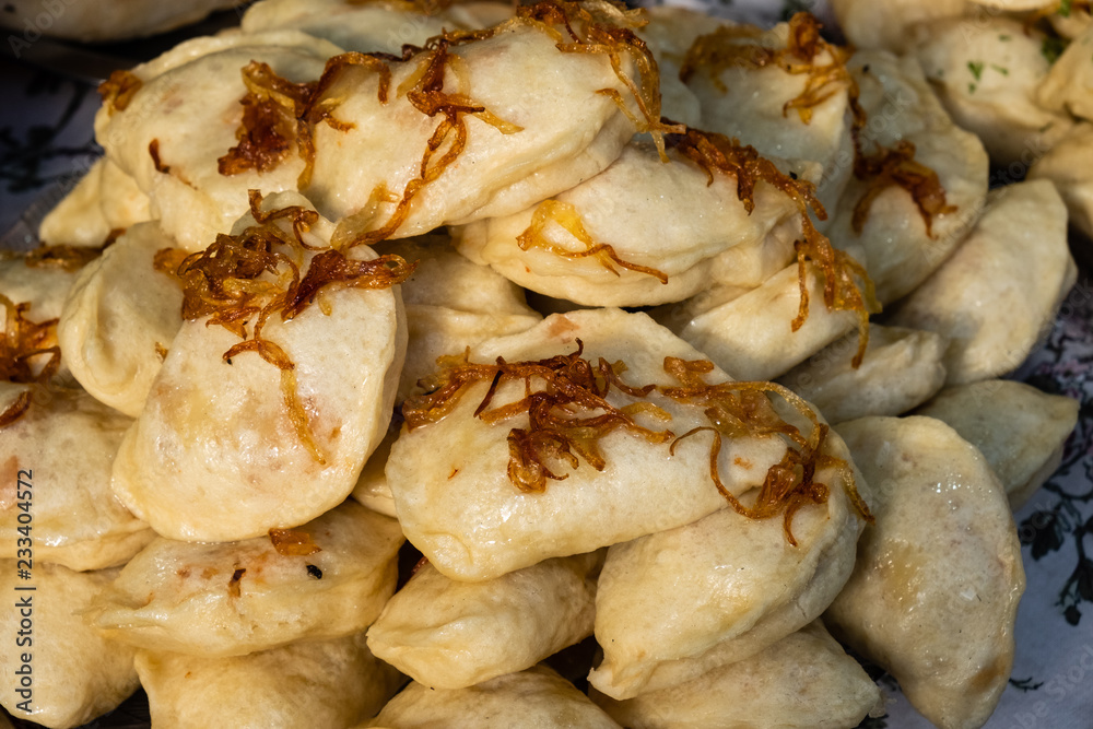 Traditional dumplings with fried onions at a street food festival Traditional dumplings with fried onions at a street food festival