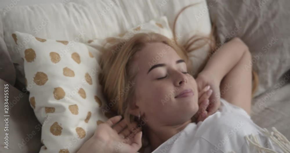 Cute girl sleeping in bed waking up Cute girl sleeping in bed waking up