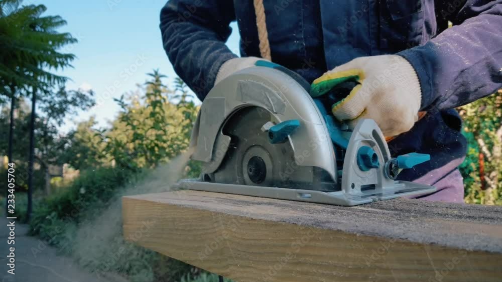 Male hands in gloves work with jack-plan Male hands in gloves work with jack-plan