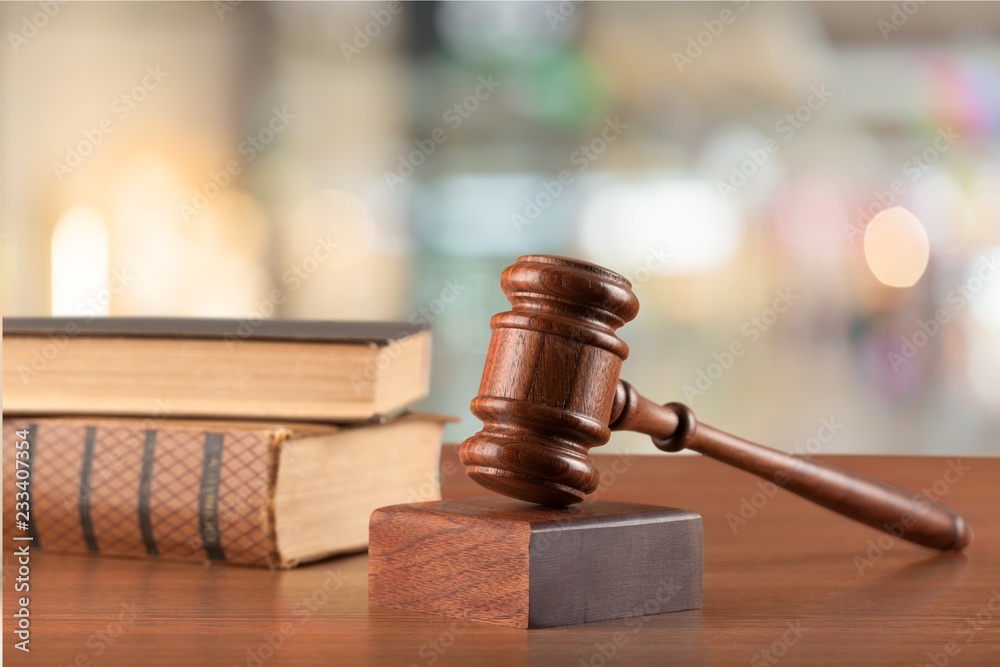 Wooden judge gavel and toy house on background Wooden judge gavel and toy house on background