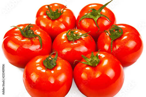 a pile of fresh red tomatoes on a white background