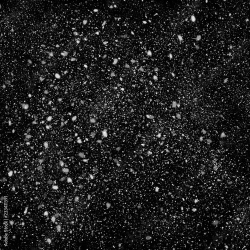 Isolated natural white snow texture effect on black night background. Winter snowflakes.