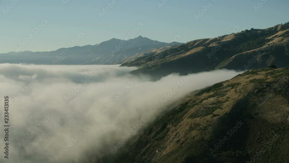 Aerial view rolling fog coastal mountains Big Sur