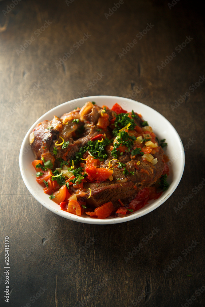 Traditional Italian Ossobuco with lemon and parsley sauce Traditional Italian Ossobuco with lemon and parsley sauce