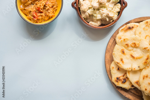 Arepas with reina pepiada and egg revueltos photo