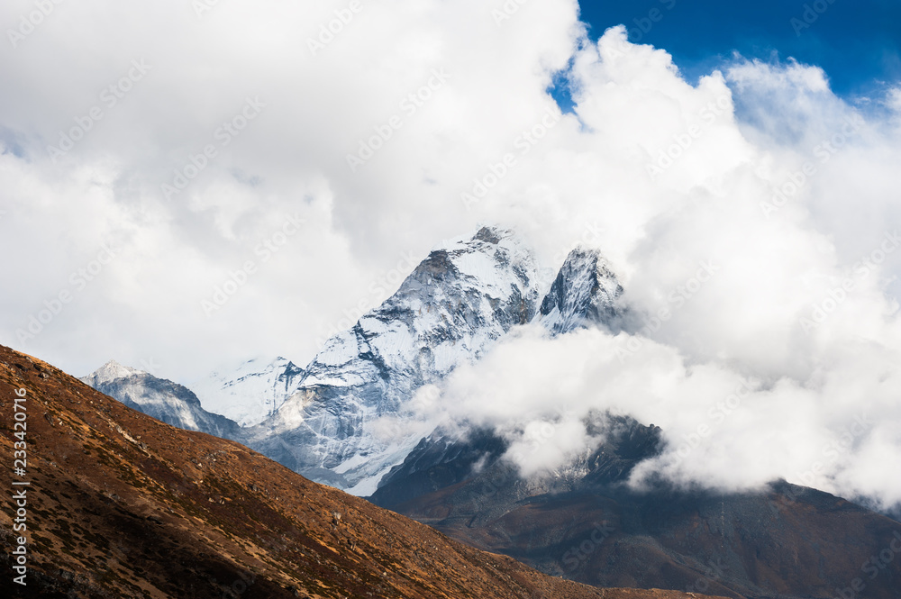 Peak of Mount Ama Dablam in the clouds, Himalayas, Nepal.