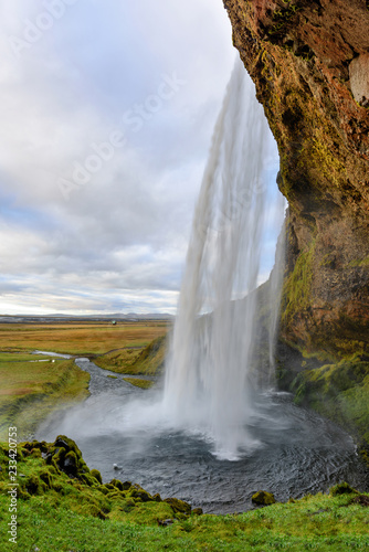 Majestic Seljalandsfoss; the most famous waterfall in Iceland. Sunset landscape. Beautiful tourist attraction in one of the main holiday destinations.
