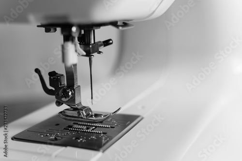 Close up of the needle of a sewing machine