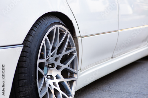 Close-up of the white stanced car wheel © nickolastock