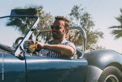 Man driving a convertible vintage car