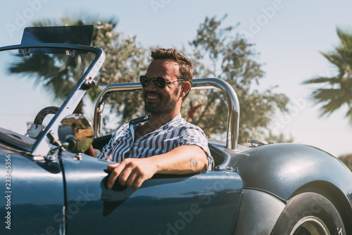Photography Man driving a convertible vintage car