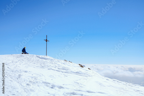 snow border sit on the top of the hill on his board in nice sunny day. Caucasus Mountains in winter, Georgia, region Gudauri, Mount Kudebi.