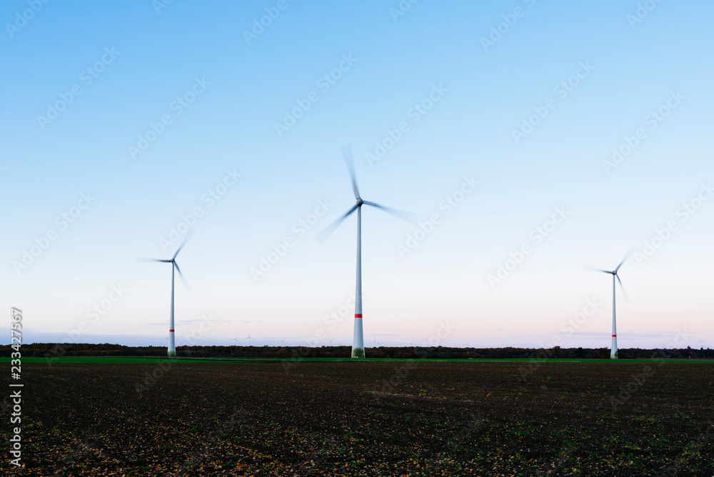 Wind turbines in the evening light on a field Rhineland Palatinate/ Germany