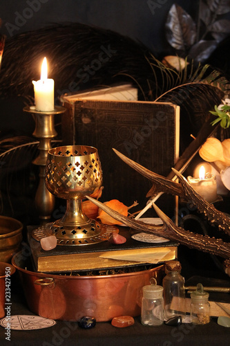 Fototapeta Naklejka Na Ścianę i Meble -  Black candle Magic Ritual. Antique Magic Book. Witchcraft  Peacock feathers and candle background.