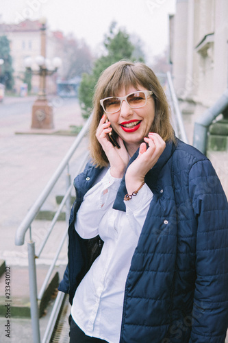 business woman with phone walk in the city