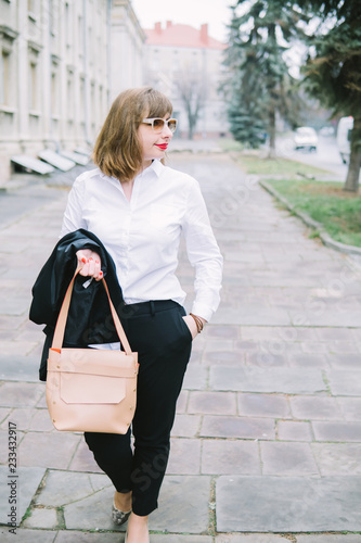 Business Women Style. Woman Going To Work Walking Downstairs. Portrait Of Beautiful Smiling Female In Stylish Office Clothes Going Old Town.