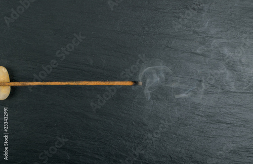 Burning incense aroma sticks with smoke on black background photo