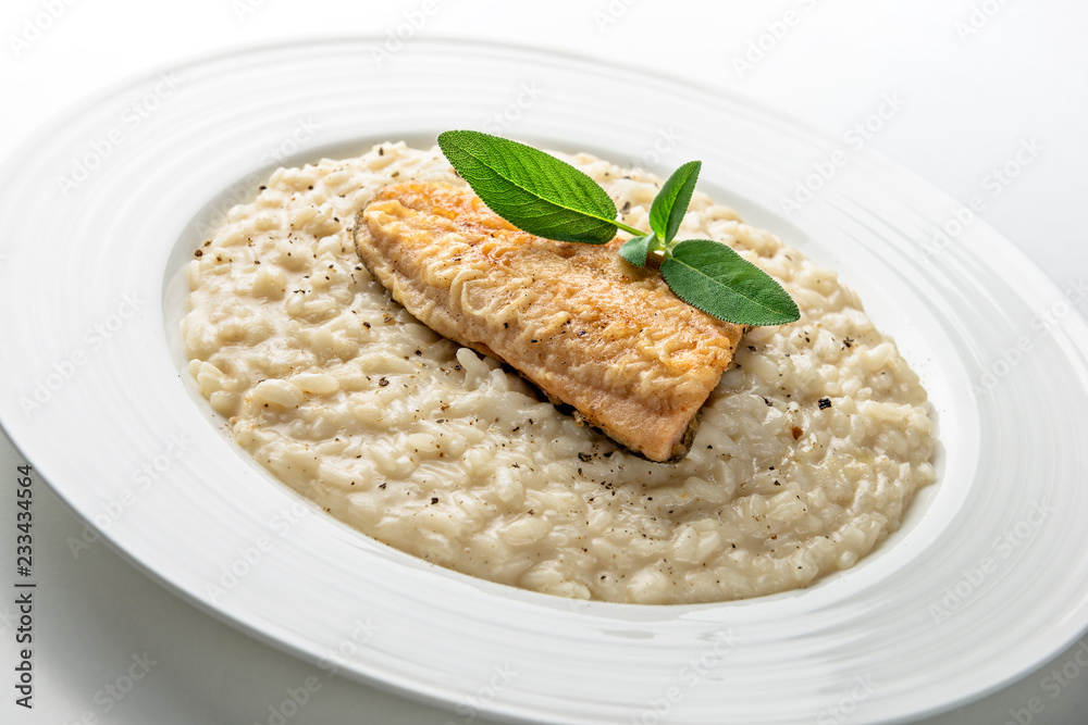 Dish of Parmesan risotto with fish fillet Dish of Parmesan risotto with fish fillet
