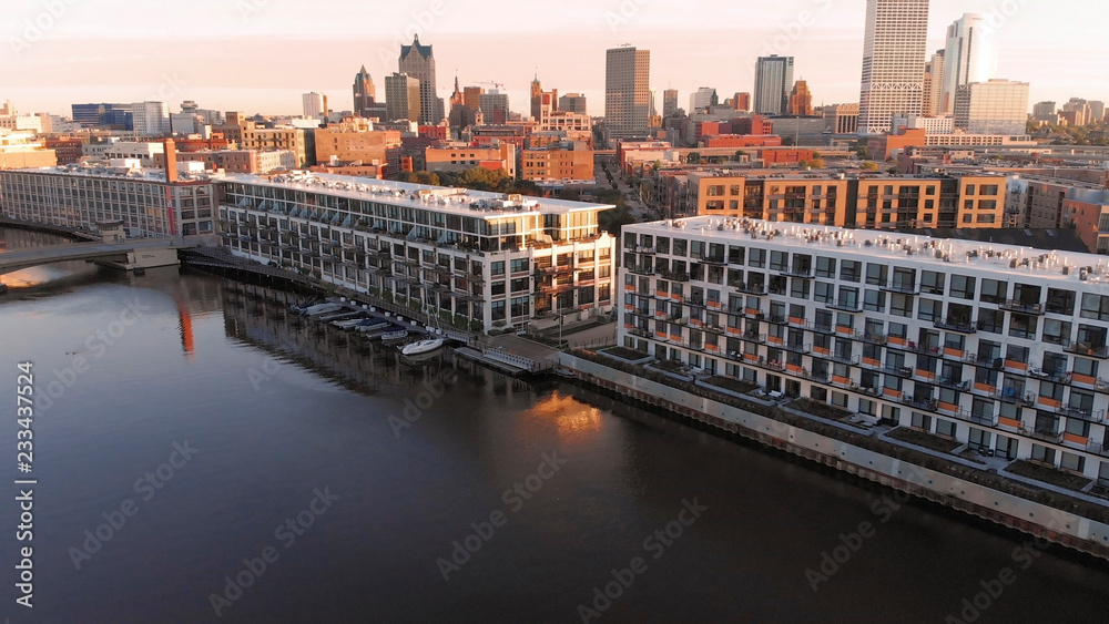 Obraz premium Milwaukee river in downtown, harbor districts of Milwaukee, Wisconsin, United States. Real estate, condos in downtown. Aerial view, drone flying