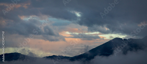 Panoramic Mountain Ridge and Dramatic Clouds at Sunset