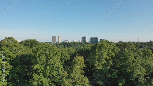 Drone shot. Rising above the trees. View of Thorncliff and Leaside. East York in the distance. Summer in Toronto, Ontario, Canada. photo