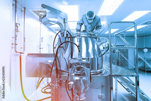 scientist look in steel tank in laboratory. Blue tone. Blue tint photo