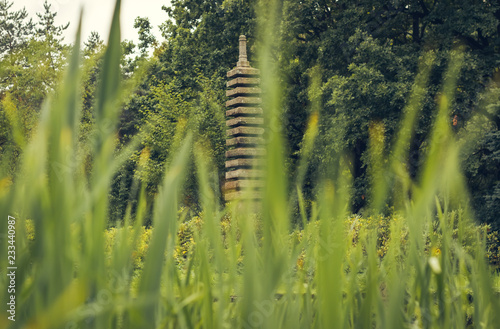 stone pagoda symbolizing a buddhist temple in a japanese garden photo