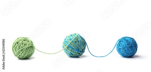 Colorful cotton thread balls from two color green and blue thread isolated on white background. Different color green and blue thread mix. photo