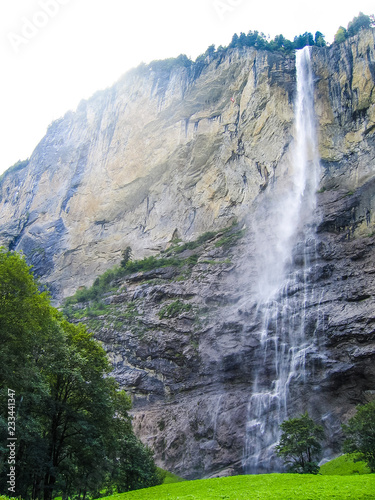 Staubbach waterfall in Interlaken  Switzerland on cliff during summer with sunlight