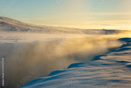 Steaming Jokulsa a Fjollum river flowing over Dettifoss waterfall, Vatnajokull National Park, Iceland on cold winters day photo