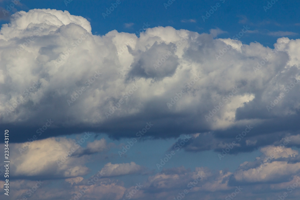 Large white cumulus clouds in the blue sky Large white cumulus clouds in the blue sky